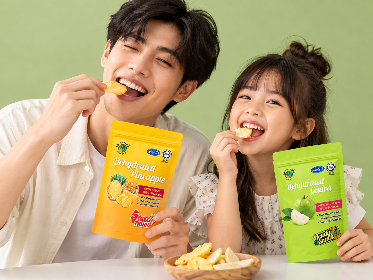 Two people snacking on BP Skyfood pineapple and guava